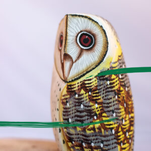 Close up of a Wooden Barn Owl on a log ornament from Shiny Happy Eco