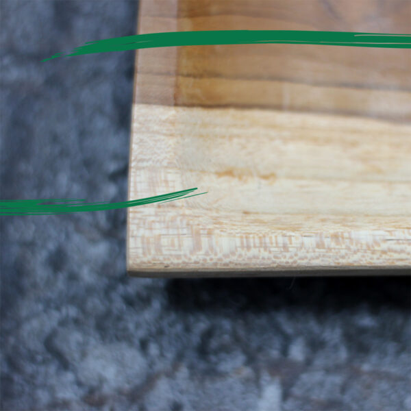 Corner details of a oblong shaped teak serving plate by Shiny Happy Eco.