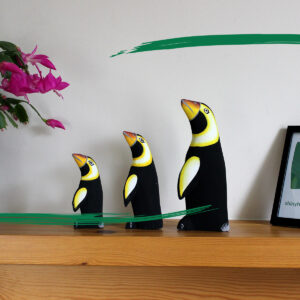 Three hand painted wooden penguin ornaments from Shiny Happy Eco.