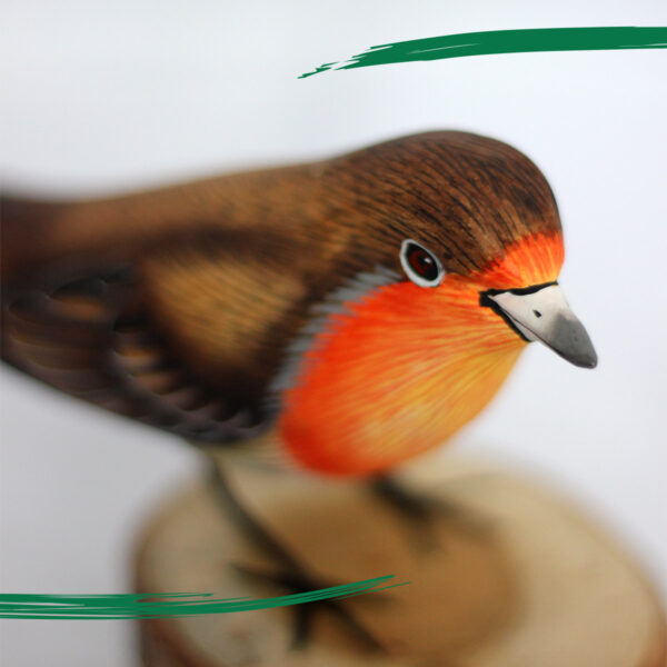 Close up of hand painted wooden Robin ornament sat on log from Shiny Happy Eco