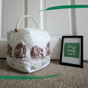 Square fabric doorstop with illustrated hedgehogs from Shiny Happy Eco