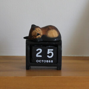Close up front view of cat block calendar in dark brown on black available from Shiny Happy Eco.