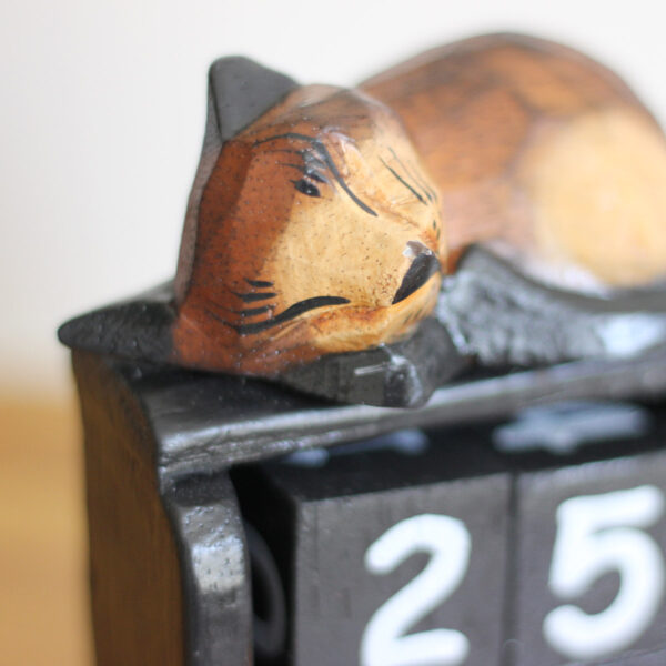Close up of head of Cat sleeping on calendar ornament in dark brown colourings available from Shiny Happy Eco.