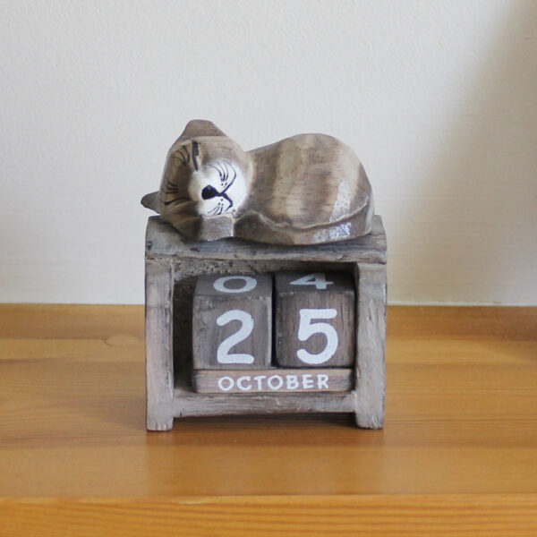 Front view of Sleeping Cat calendar ornament in light brown colourings available from Shiny Happy Eco.