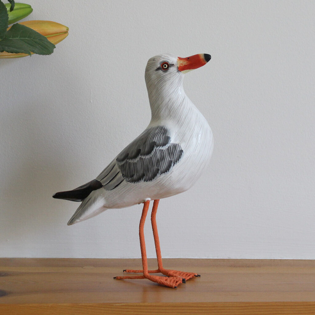 Wooden Painted Seagull ornament on shelf - hand made and hand painted. Available from Shiny Happy Eco.