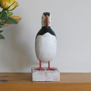 Front view of a Wooden Puffin ornament, hand made and painted in a rustic style and available from Shiny Happy Eco.