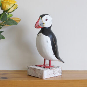 Wooden Puffin ornament on a plinth, hand made and painted in a rustic style and available from Shiny Happy Eco.