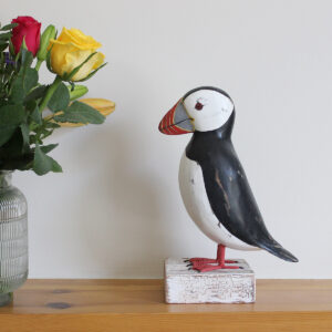 Side view of Wooden Puffin ornament on a stand, hand made and painted in a rustic style and available from Shiny Happy Eco.