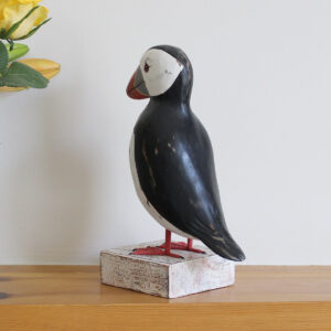 Wooden Puffin ornament on a plinth, hand made and painted in a rustic style and available from Shiny Happy Eco.