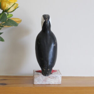Rear view of a Wooden Puffin ornament, hand made and painted in a rustic style and available from Shiny Happy Eco.
