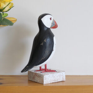Wooden Puffin ornament on a stand, hand made and painted in a rustic style and available from Shiny Happy Eco.