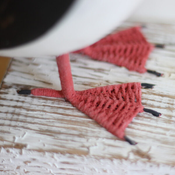 Close up of the feet detail on a Wooden Puffin ornament, hand made and painted in a rustic style and available from Shiny Happy Eco.