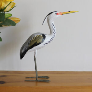 Side view of Wooden Heron ornament handmade and hand painted on mantlepiece available from Shiny Happy Eco.