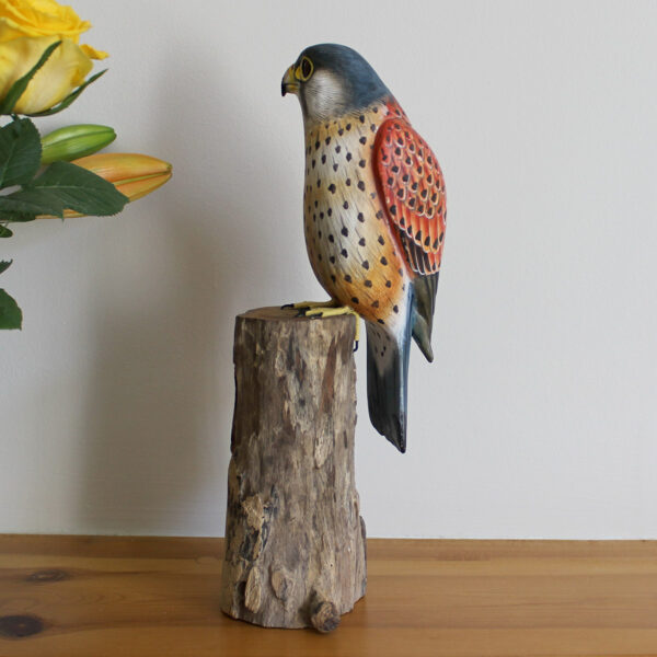 Side view of handmade Wooden Kestrel Ornament on mantelpiece available from Shiny Happy Eco