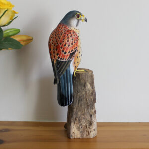 Side view of handmade and handprinted Wooden Kestrel Ornament on mantelpiece available from Shiny Happy Eco