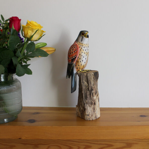 Wooden Kestrel Ornament on mantelpiece next to flowers available from Shiny Happy Eco