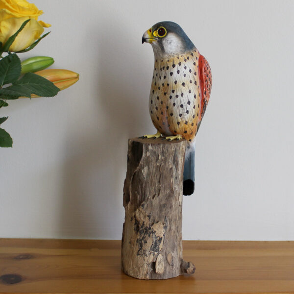 Side view of hand made Wooden Kestrel Ornament on mantelpiece available from Shiny Happy Eco