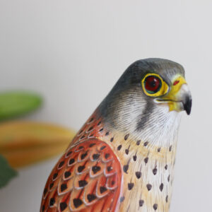 Close up of top part of Wooden Kestrel Ornament on mantelpiece available from Shiny Happy Eco