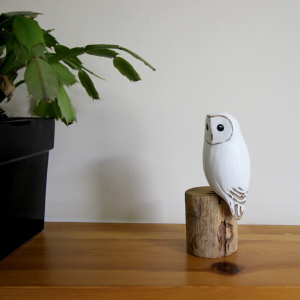 Wooden Snowy Owl ornament hand carved and painted with plant on mantlepiece from Shiny Happy Eco