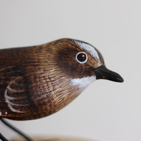 Close up of head of Hand carved and painted Wooden Wren Ornament on driftwood available from Shiny Happy Eco.